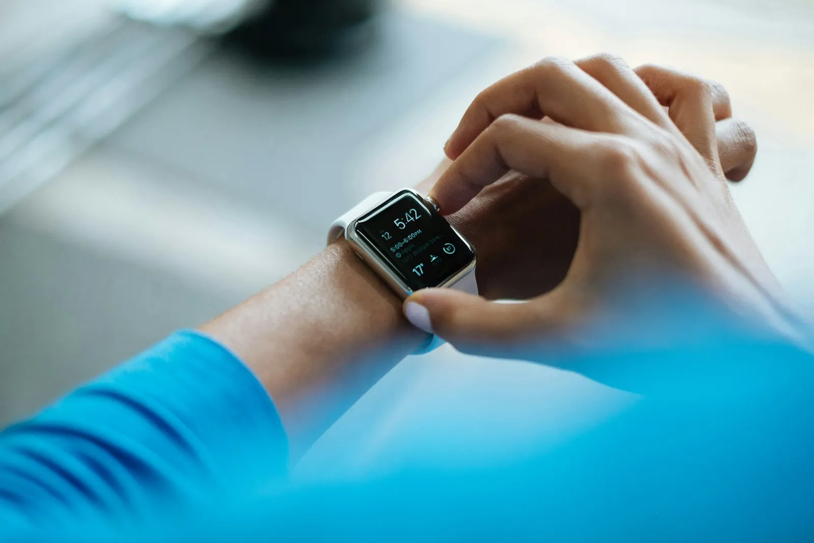 A person wearing a smartwatch on their wrist