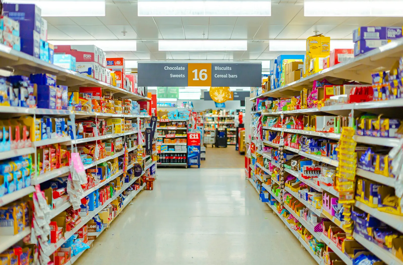 Supermarket shelves stocked with packaged snacks